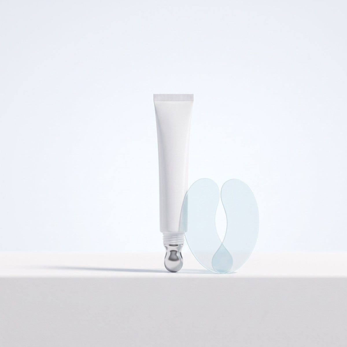 Eye cream tube with a metal tip and gel eye patches