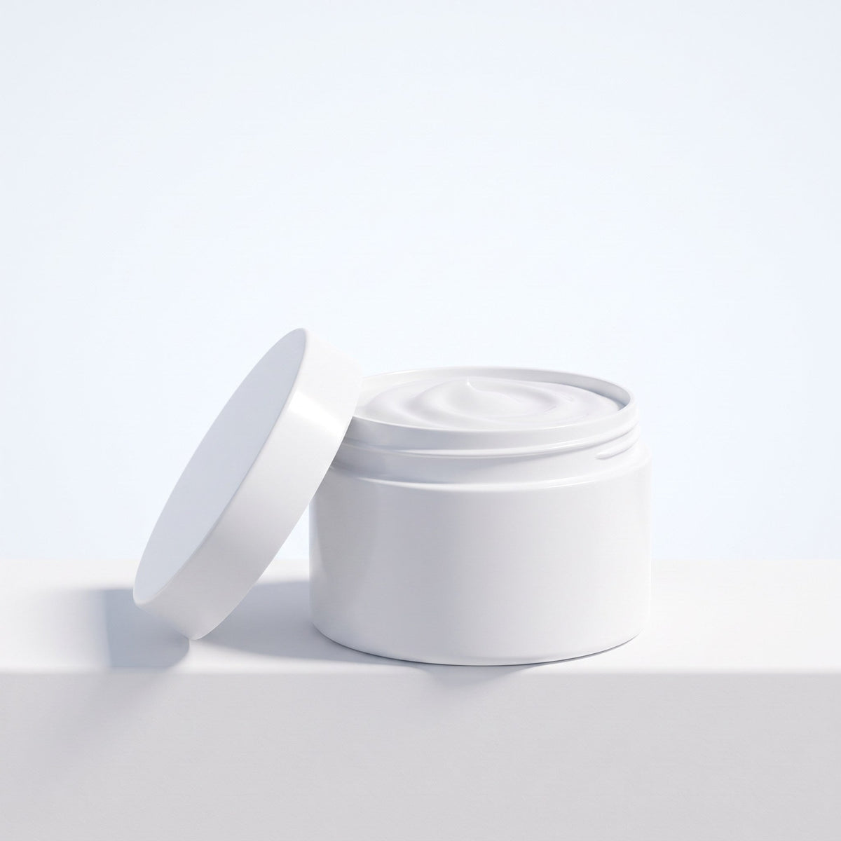 Open jar of white moisturizing cream