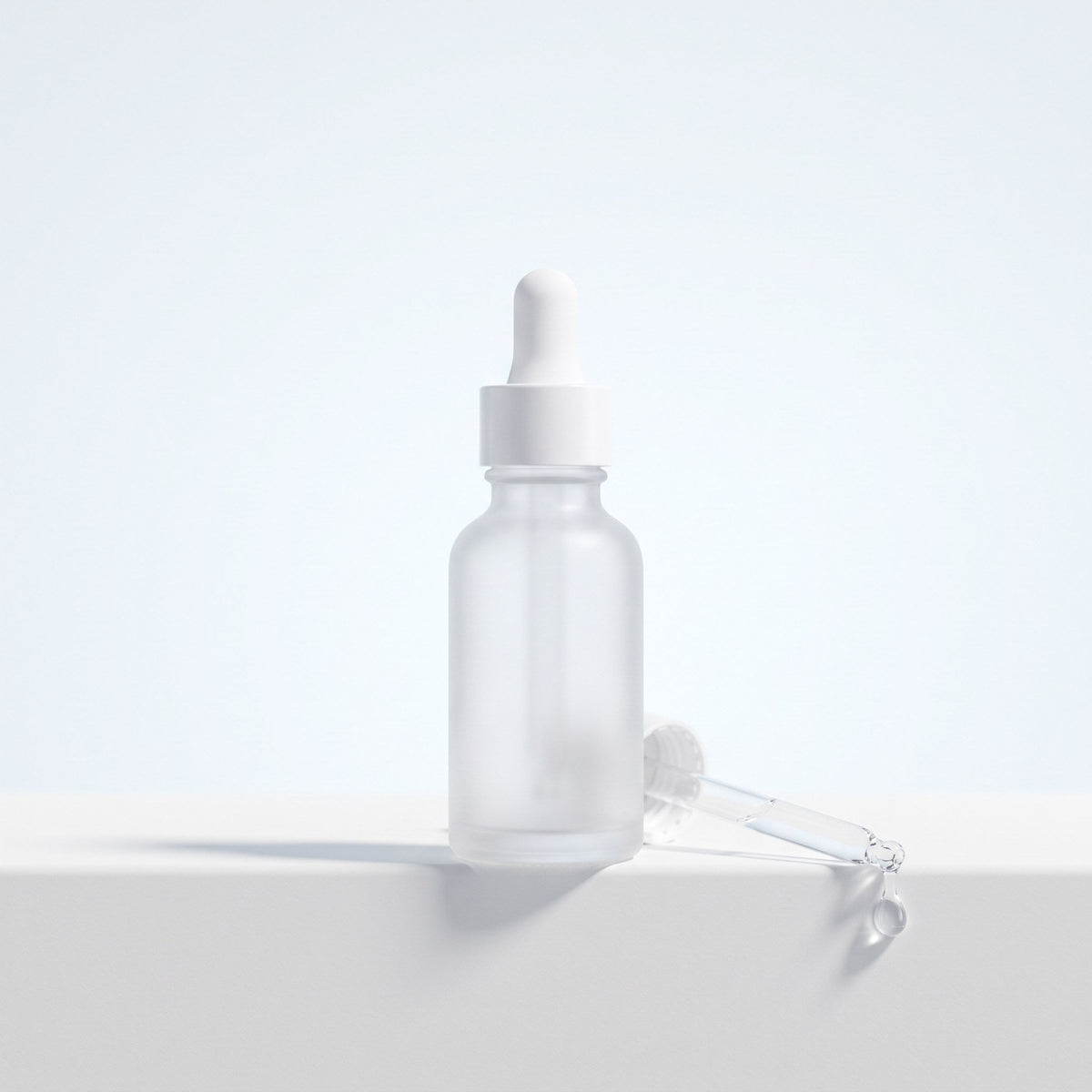 Frosted dropper bottle with a drop of serum