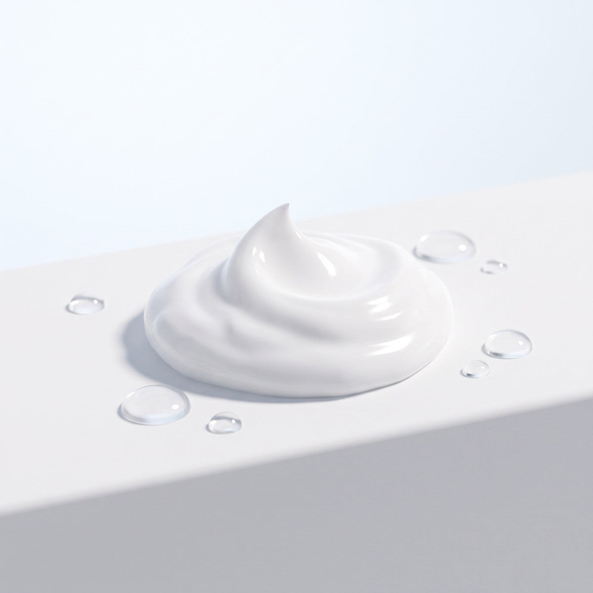 Swirl of rich white cream with water droplets