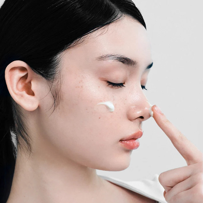 Applying 345 Relief Cream to the face