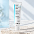 NIDA Ultimate Moisturizing Cream 100 ml, sobre piedra clara.